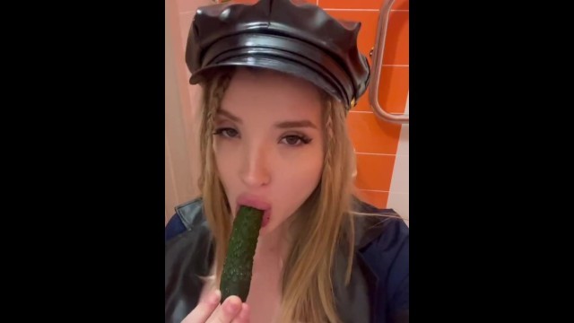 A Baby with Bare Tits Plays with a Cucumber and Sucks it with her Mouth.